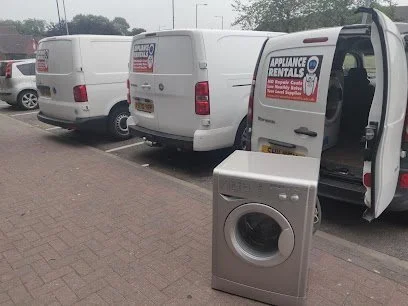Mr Wash vans outside the shop with a washing machine being loaded