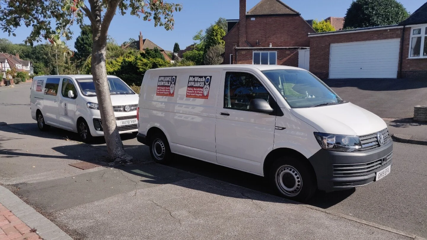Two Mr Wash Appliances vans parked on a residential street in Birmingham